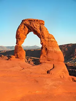 Arches: Delicate Arch rock arch in the evening sun, Arches