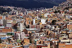 Tower: Dense urban development in front of a mountain landscape