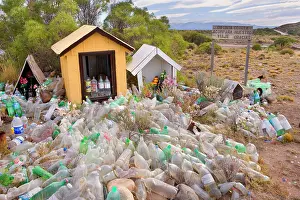 Piled: Difunta Correa roadside shrine - numerous water