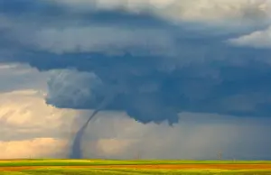 Severe: A dirt-filled debris cloud of a weakening tornado