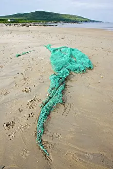 Discarded: Discarded fishing net washed up on beach