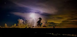 Storm: A distant thunder storm and sky draws contrast to the dark