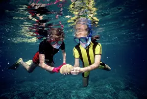 Snorkeller: DIVER - children snorkeling holding a Pincushion Starfish