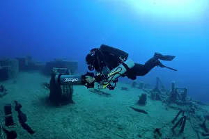 Scooter: Diver exploring with scooter the LST 349, a British Landing