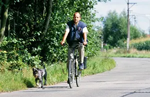 Bikes: DOG - Man on bike with Schnauzer Dog