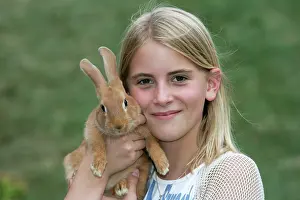 Stroking: Domestic Rabbit - being held by girl