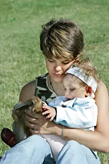 Stroking: Domestic Rabbit - being held by girl with baby