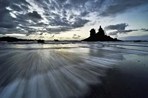 Flood: Dramatic clouds with rock formation at rising tide at the beach of Playa de Benijo
