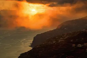 Arco: Dramatic cloudy sky at sunset, steep coast near