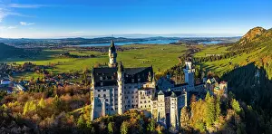 Fairytale: Drone shot, Neuschwanstein Castle in autumn, Forggensee