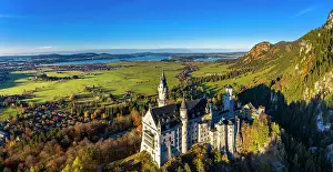 Fairytale: Drone shot, Neuschwanstein Castle in autumn, Forggensee