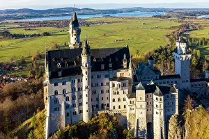 Fairytale: Drone shot, Neuschwanstein Castle in autumn, Forggensee