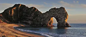 Devon: Durdle Door, a natural limestone arch at sunset