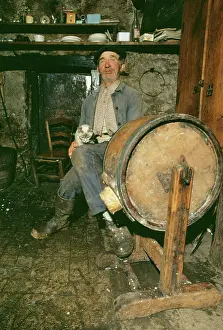 Butter: Elderly French Man - sitting with cat making butter