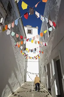 Whitewashed: Elderly man in an alley with brilliantly whitewashed