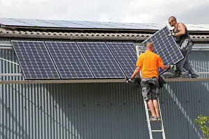 Roofs: Two engineers installing photovoltaic solar PV