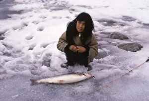 Inuit: Eskimo girl with just caught Arctic Char