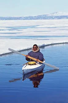 Inuit: Eskimo / Inuit hunter in skin kayak by ice floe
