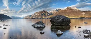 Como: Evening atmosphere at Lago di Como with large boulders in the water