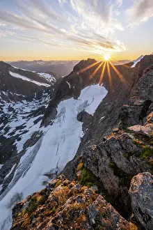 Reflex: Evening atmosphere, sun shining over mountains in
