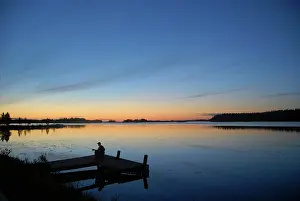 Fisherman: Evening mood with a fisherman on Lake Saimaa, Finland
