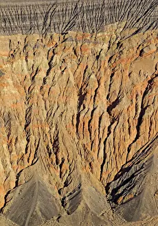 Fissured: Exposed fissured bedrock of reddish orange coloured