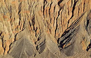 Fissured: Exposed fissured bedrock of reddish orange coloured