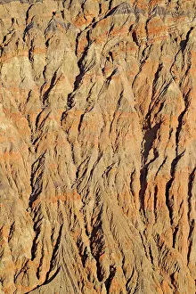 Fissured: Exposed fissured bedrock of reddish orange coloured