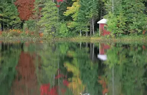 Huts: Fall coloured forest at a lake in the Adirondack
