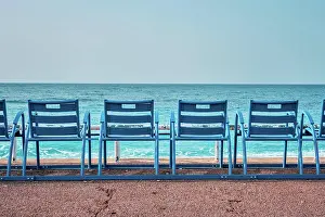 Chairs: Famous blue chairs bench on beach in the morning