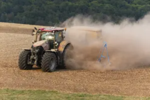 Tractors: Farm Tractor - veiled in dust, sowing out seed