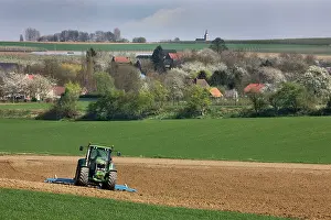 Ploughing: Farming - agricultural landscape with tractor ploughing