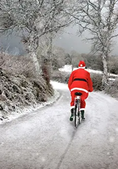 Bicycles: Father Christmas - on bicycle in winter snow scene