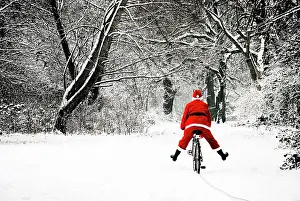 Bikes: Father Christmas - in snow - on bicycle freewheeling