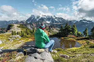 Baker: Female hiker resting on a rock at a small mountain