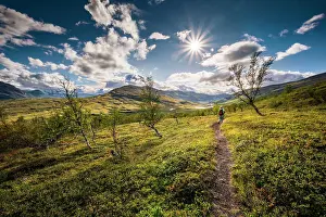 Reflex: Female hiker in wide landscape, Abisko National