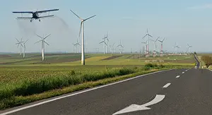 Plane: Field of wind turbines in intensive cereal crops
