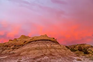 Dakota: Fiery sunrise clouds over badlands at dawn