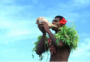 Blowing: FIJI - man blowing into conch shell