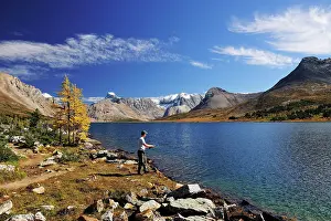 Fisherman: A fisherman with a fishing rod is standing on the