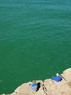 Fishermen on high cliffs above the Atlantic Ocean