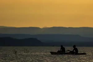 Baringo: Fishermen - silhouette at sunset. Lake Baringo, Kenya