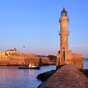 Harbor: Fishing boat passing by Egyptian Lighthouse lit