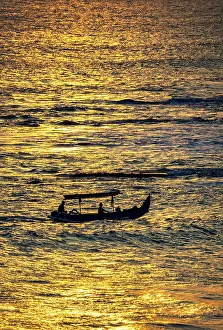 Fishing Boat: Fishing boat returning to shore in a blaze of gold sunset