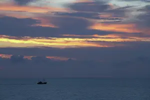 Northsea: Fishing boat at sea just after sunset, The Netherlands