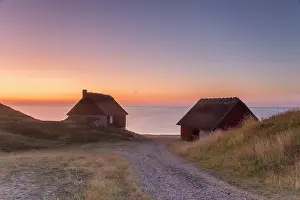 Huts: Fishing huts at the coast of Havaeng at sunrise