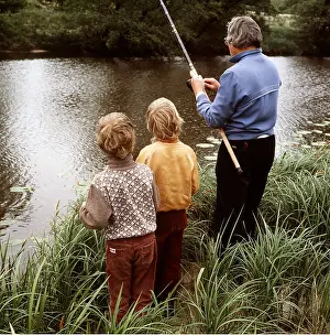 Anglers: FISHING - Man with children by river