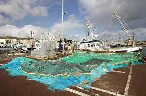 Quay: Fishing nets and trawlers on quayside