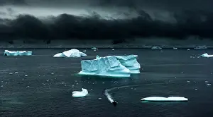 Zodiac: Floating ice and moody sky with expedition rubber