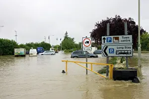 Opposite: Flooding - Cars partly submerged in flooded car